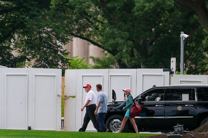 Donald Trump walks back to the White House with Executive Assistant to the President Natalie Harp