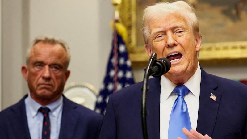 FILE PHOTO: U.S. President Donald Trump, next to U.S. Secretary of Health and Human Services Robert F. Kennedy Jr., makes an announcement linking autism to childhood vaccines and to the use of popular pain medication Tylenol for pregnant women and children, claims which are not backed by decades of science, at the White House, in Washington, D.C., U.S., September 22, 2025. REUTERS/Kevin Lamarque/File Photo