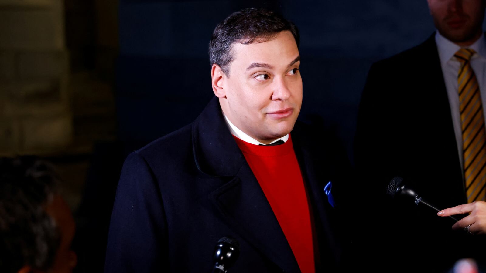 George Santos talks to reporters while walking to attend a vote on whether the House of Representatives will expel him