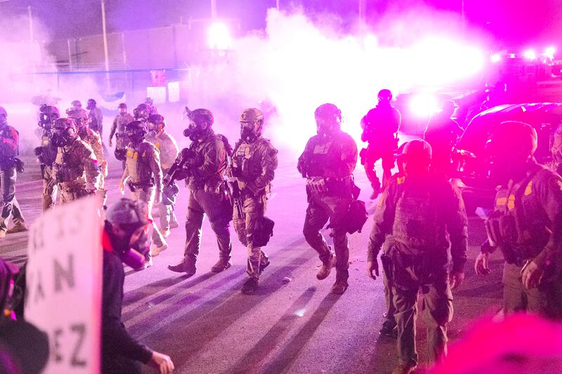 Federal law enforcement agents attack demonstrators protesting outside of an immigrant processing center with a barrage of tear gas and pepper balls