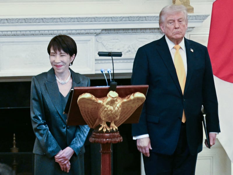 Japan's Prime Minister Sanae Takaichi speaks while US President Donald Trump looks on during a dinner in the State Dining Room of the White House in Washington on March 19, 2026.