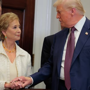 U.S. President Donald Trump speaks with Secretary of Education Linda McMahon.