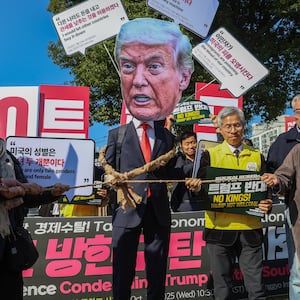 Protesters with placards reading 'No Kings, Trump not welcome' chant slogans during a protest against Unites States President Donald Trump, who is arriving today for the APEC Leaders Week, in Geyongju, South Korea, on October 29, 2025.