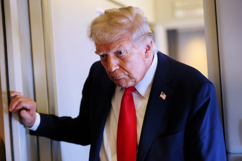 President Donald Trump speaks to reporters on Air Force One on September 18, 2025 during a flight to Joint Base Andrews, Maryland.