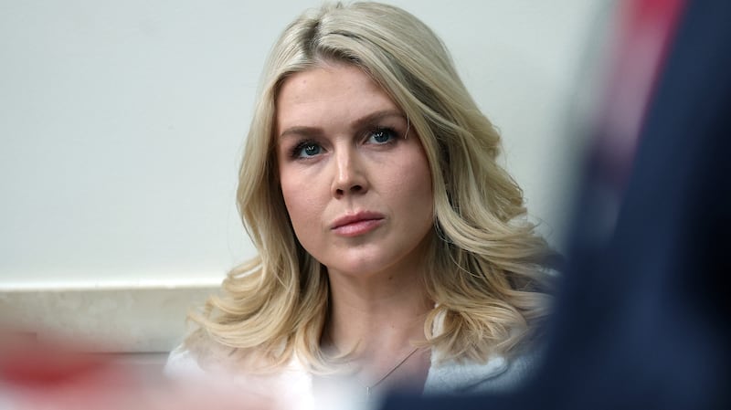 White House Press Secretary Karoline Leavitt listens as U.S. President Donald Trump speaks during a press briefing in the James S. Brady Press Briefing Room of the White House on January 20, 2026 in Washington, DC.