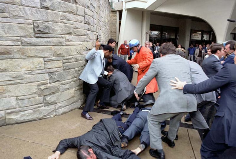 White House Press Secretary James Brady and DC Thomas Delahanty  lie wounded on the ground after John Hinckley Jr. fired six shots at President Ronald Reagan outside the Washington Hilton Hotel in Washington, DC, U.S. on March 30, 1981.
