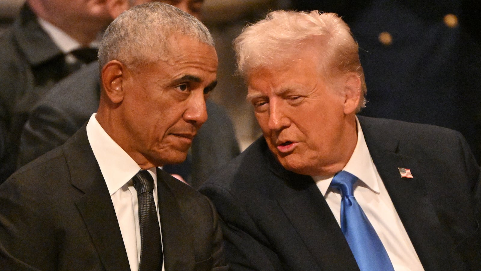 Former US President Barack Obama speaks with President Donald Trump.