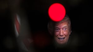 President Donald Trump participates in a call with U.S. service members from his Mar-a-Lago club