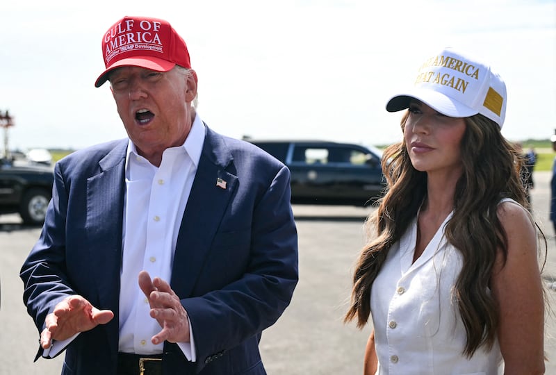 (L/R) US President Donald Trump, alongside Secretary of Homeland Security Kristi Noem, speaks to reporters after arriving at Dade-Collier Training and Transition Airport in Ochopee, Florida, on July 1, 2025. President Trump is visiting a migrant detention center in a reptile-infested Florida swamp dubbed "Alligator Alcatraz." Trump will attend the opening of the 5,000-bed facility -- located at an abandoned airfield in the Everglades wetlands -- part of his expansion of deportations of undocumented migrants, his spokeswoman said. (Photo by ANDREW CABALLERO-REYNOLDS / AFP) (Photo by ANDREW CABALLERO-REYNOLDS/AFP via Getty Images)