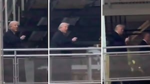 Donald Trump points and flips the bird at a factory worker.