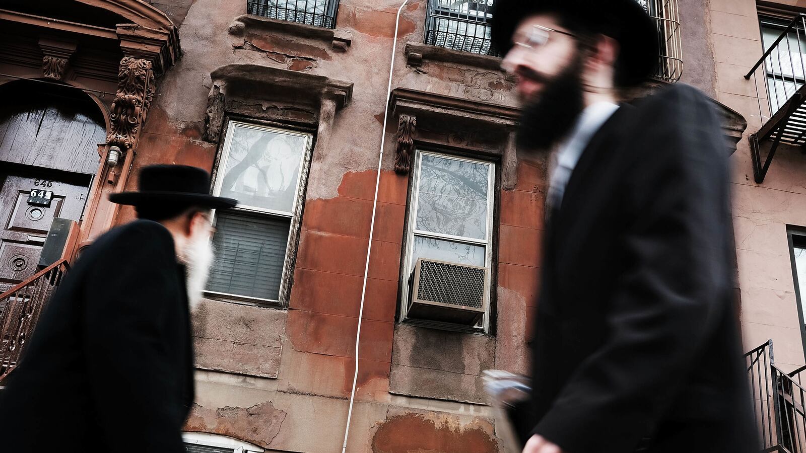 hasidic men walking through a jewish orthodox neighborhood in williamsburg brooklyn measles mmr vaccine anti vaxxer vaccination