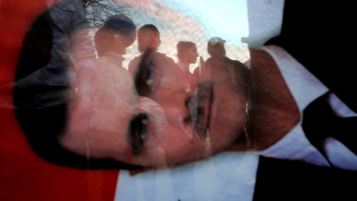 cheats/2012/03/17/sexy-photo-found-in-assad-emails/assad-syria-flag-reflection-cheat_jmnbcc