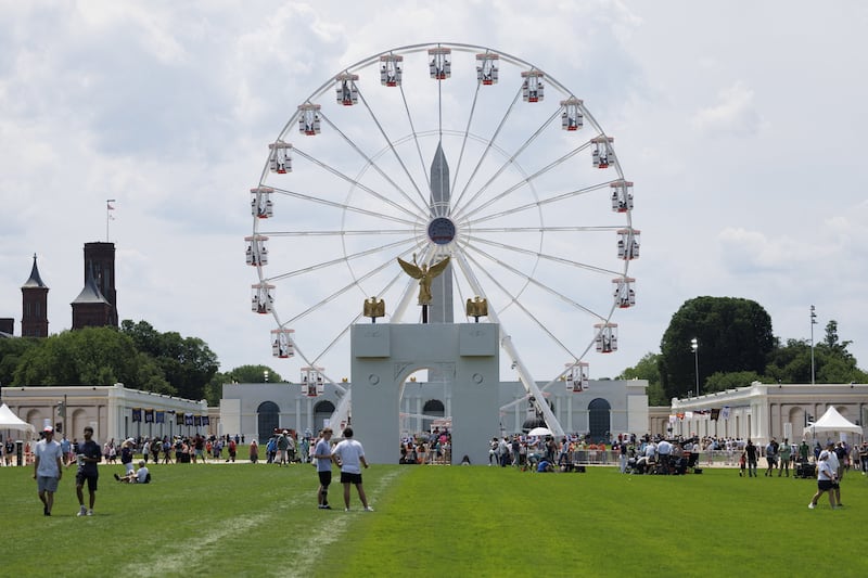 Visitors walk across the Great American State Fair on the National Mall in Washington, D.C., U.S., June 25, 2026.