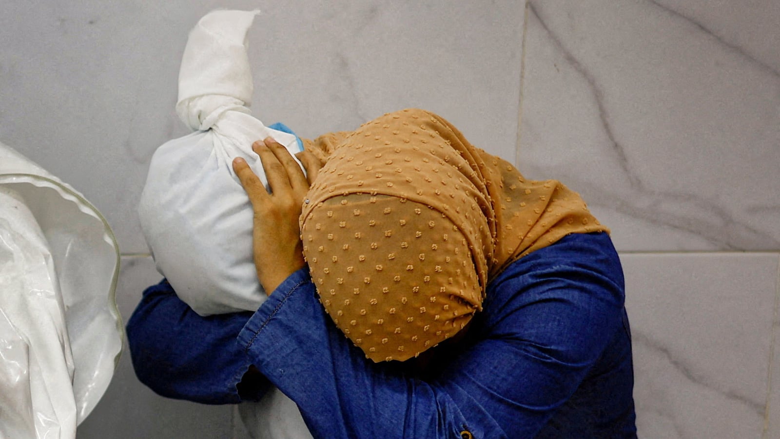 Mohammed Salem won the 2024 World Press Photo of the Year award for this image showing Palestinian woman Inas Abu Maamar, 36, embracing the body of her 5-year-old niece Saly, who was killed in an Israeli strike.