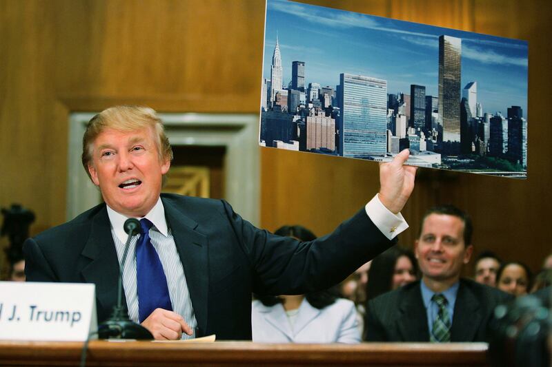 Donald Trump, president of the Trump Organization, displays a picture of the New York City skyline