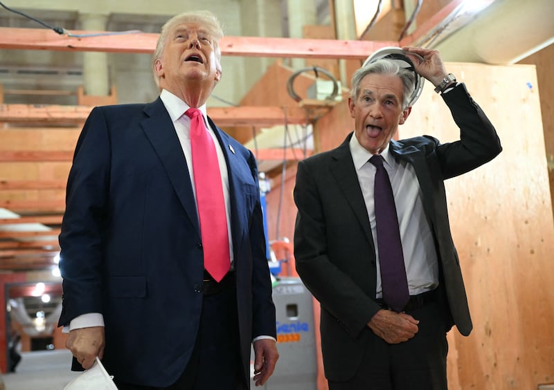 President Donald Trump speaks with Federal Reserve chair Jerome Powell (R) as he visits the Federal Reserve in Washington, DC, on July 24, 2025.