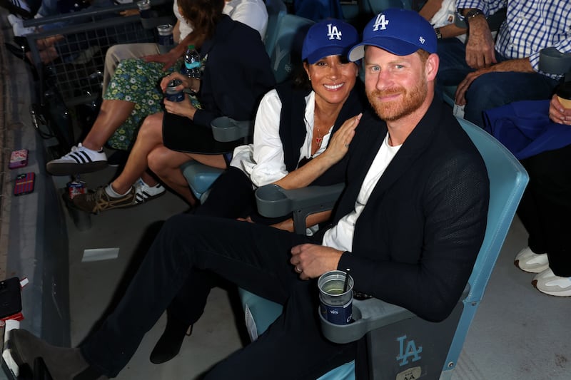 LOS ANGELES, CA - OCTOBER 28:  Prince Harry, Duke of Sussex and Meghan, Duchess of Sussex pose for a photo during Game Four of the 2025 World Series presented by Capital One between the Toronto Blue Jays and the Los Angeles Dodgers at Dodger Stadium on Tuesday, October 28, 2025 in Los Angeles, California.