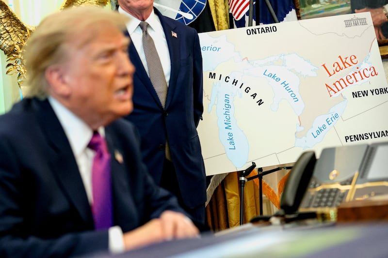 Trump speaks next to a map with "Lake America" written on it as he signs an executive order renaming Lake Ontario.