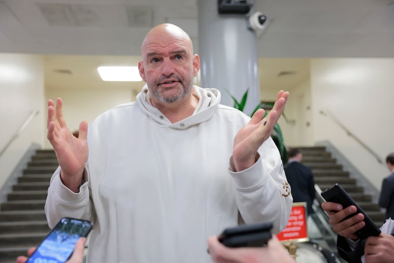 WASHINGTON, DC - FEBRUARY 12: U.S. Sen. John Fetterman (D-PA) speaks to reporters in the Senate Subway during a series of confirmation votes for U.S. President Donald Trump's cabinet nominees at the U.S. Capitol Building on February 12, 2025 in Washington, DC. The Senate voted to confirm Tulsi Gabbard as Director of National Intelligence and completed a procedural vote for the confirmation of Robert F. Kennedy Jr. as Secretary of Health and Human Services. (Photo by Anna Moneymaker/Getty Images)