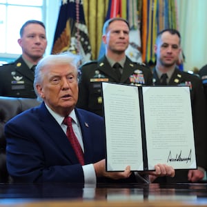 WASHINGTON, DC - DECEMBER 15: U.S. President Donald Trump poses with a recently signed executive order classifying fentanyl as a "weapon of mass destruction," during a ceremony for the presentation of the Mexican Border Defense Medal in the Oval Office of the White House on December 15, 2025 in Washington, DC. During the ceremony, Trump recognized the first 13 service members to receive the recently established Mexican Border Defense Medal (MBDM), which recognizes service members supporting Customs and Border Protection on the U.S.-Mexico border. (Photo by Anna Moneymaker/Getty Images)