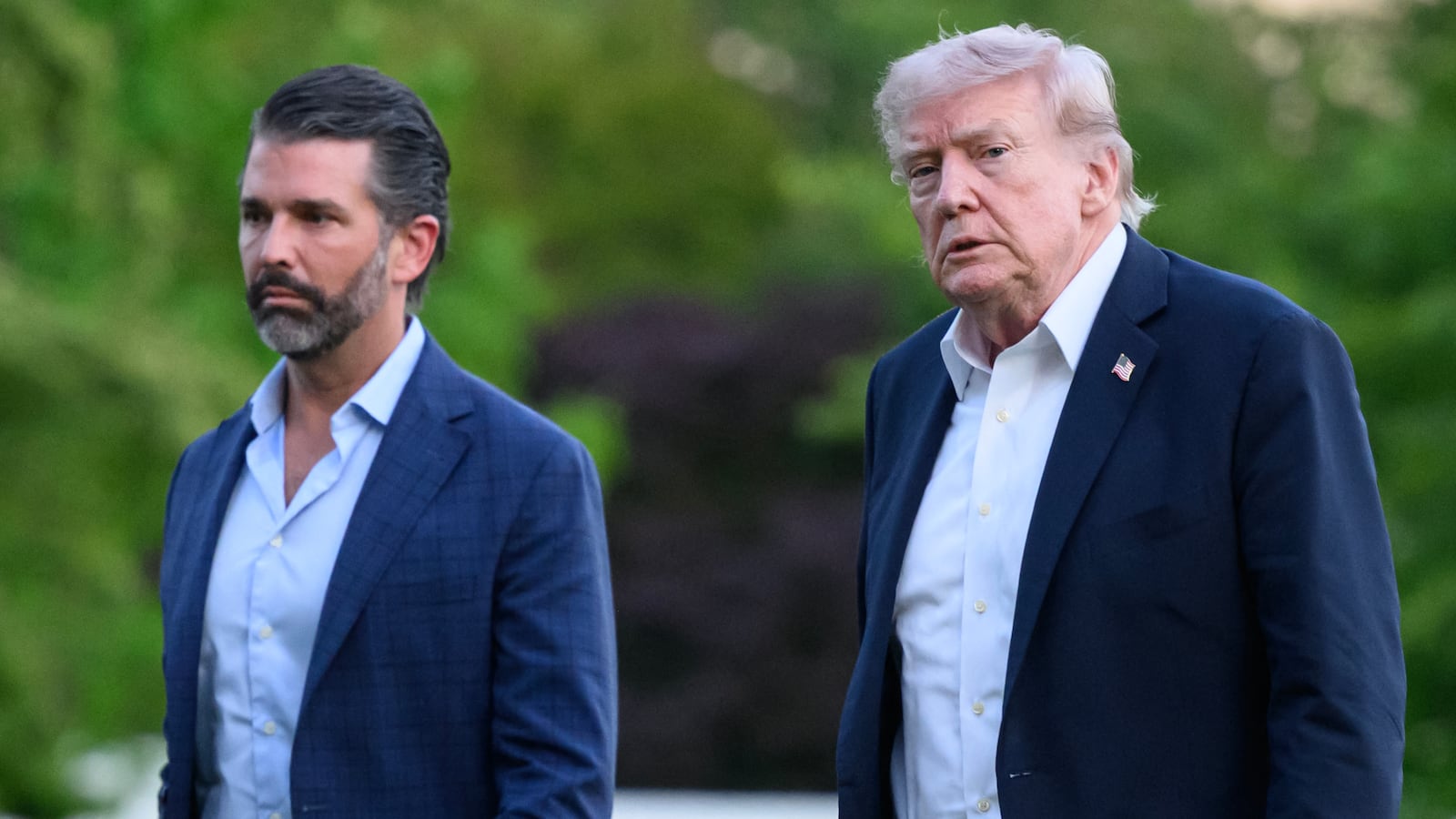 US President Donald Trump and Donald Trump Jr. walk on the south lawn toward the White House in Washington, DC, on May 3, 2026. Trump spent the weekend at his Mar-a-Lago resort in Palm Beach, Florida and his Doral Miami resort. (Photo by Mandel NGAN / AFP via Getty Images)