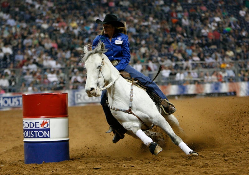 Jill Moody races around a barrel.