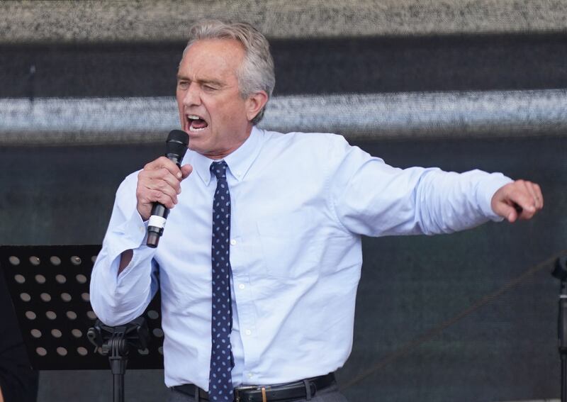 BERLIN, GERMANY - AUGUST 29: Robert F. Kennedy Jr., nephew of former U.S. President John F. Kennedy, speaks to people from a wide spectrum, including coronavirus skeptics, conspiracy enthusiasts, right-wing extremists, religious conservatives, hippies and others gathered under the Victory Column in the city center to hear speeches during a protest against coronavirus-related restrictions and government policy on August 29, 2020 in Berlin, Germany. City authorities had banned the planned protest, citing the flouting of social distancing by participants in a similar march that drew at least 17,000 people a few weeks ago, but a court overturned the ban. (Photo by Sean Gallup/Getty Images)
