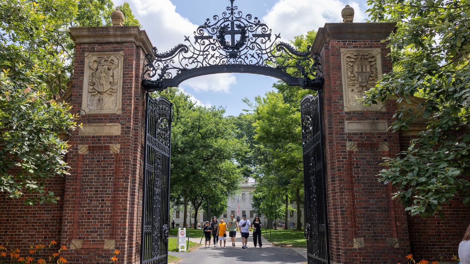 People walk through the gate on Harvard Yard at the Harvard University campus on June 29, 2023 in Cambridge, Massachusetts.