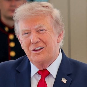 U.S. President Donald Trump reacts after being given a personalised racing helmet during a Freedom 250 Grand Prix Showcase at the White House in Washington, D.C., U.S., July 13, 2026.