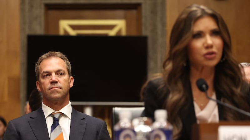 Bryon Noem (L), husband of US Secretary of Homeland Security Kristi Noem (R), listens  as Secretary Noem testifies before the Senate Committee on Homeland Security and Governmental Affairs to examine the President's proposed budget request for fiscal year 2026 for the Department of Homeland Security, on Capitol Hill in Washington, DC, May 20, 2025. (Photo by Alex WROBLEWSKI / AFP) (Photo by ALEX WROBLEWSKI/AFP via Getty Images)