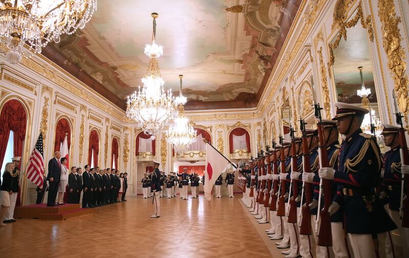 President Donald Trump views an honor guard with Japanese Prime Minister Sanae Takaichi at Akasaka Palace