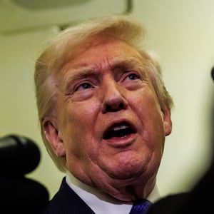 President Donald Trump gaggles with reporters while aboard Air Force One on February 6, 2026 en route to Palm Beach, Florida.