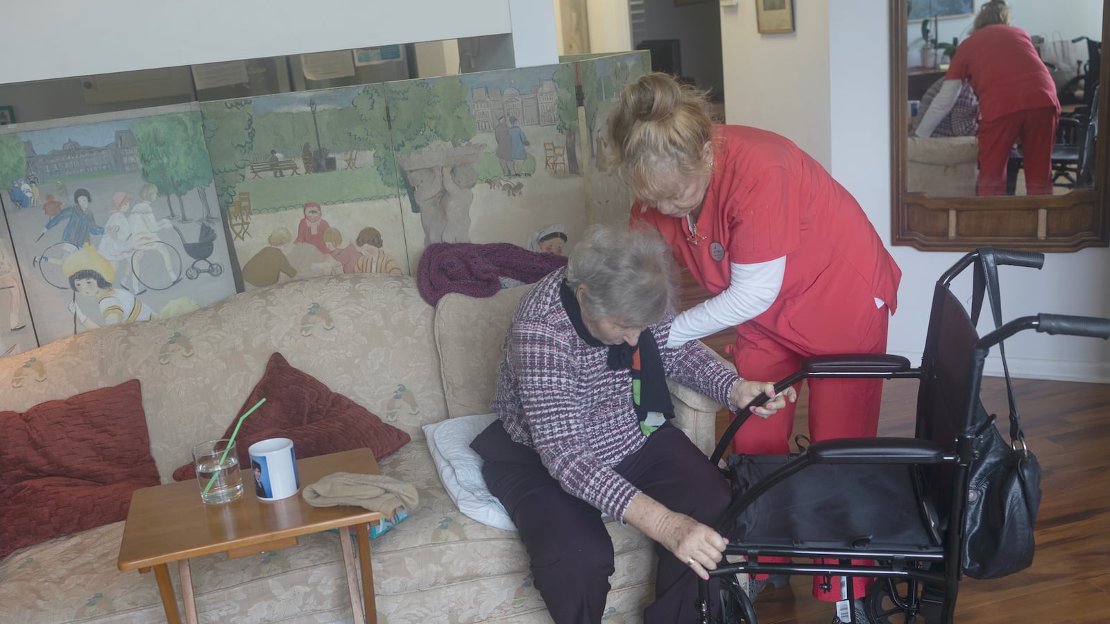 A home health care nurse helps an elderly woman in Florida in September 2024.