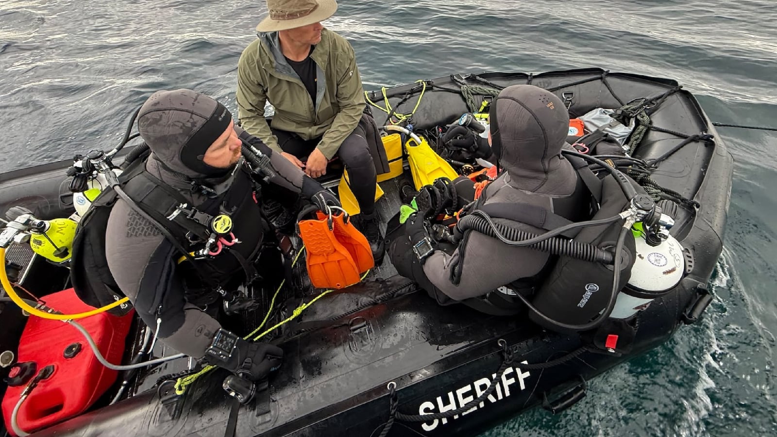 Divers search for a missing swimmer.