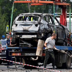 A crane lifts a wrecked car at the scene of a car explosion, which killed the driver, in the city of Balashikha in the Moscow region, Russia, June 9, 2026.