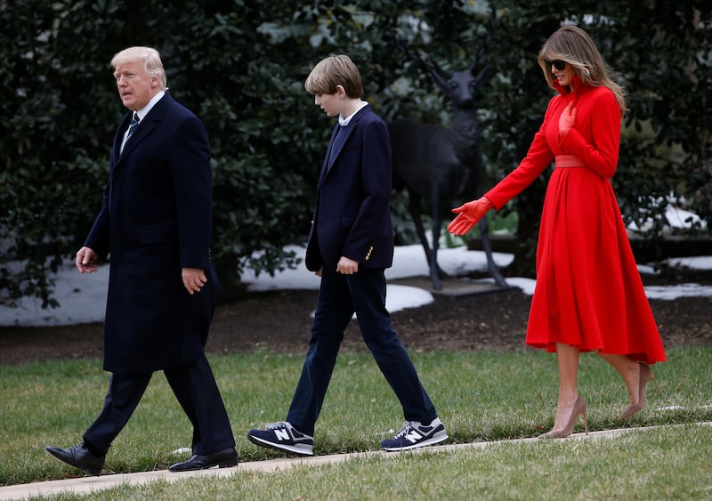 Donald and Melania walk with Barron to Marine One at the White House, a few months into the president's first term.