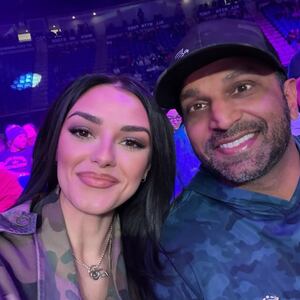 Alexis Wilson and Kash Patel next to a plane taking off