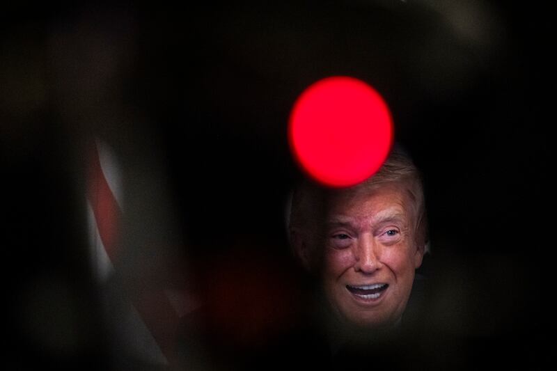 President Donald Trump participates in a call with U.S. service members from his Mar-a-Lago club