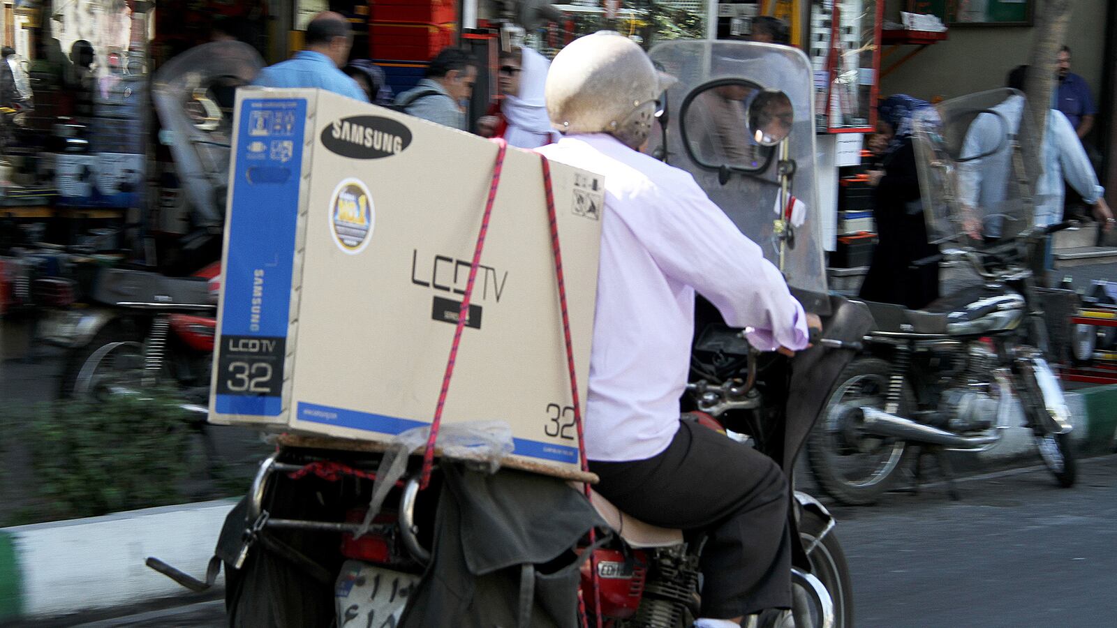 articles/2013/10/17/don-t-offer-sanctions-relief-to-iran/OZ_Tehran_motorbike_c77eyo