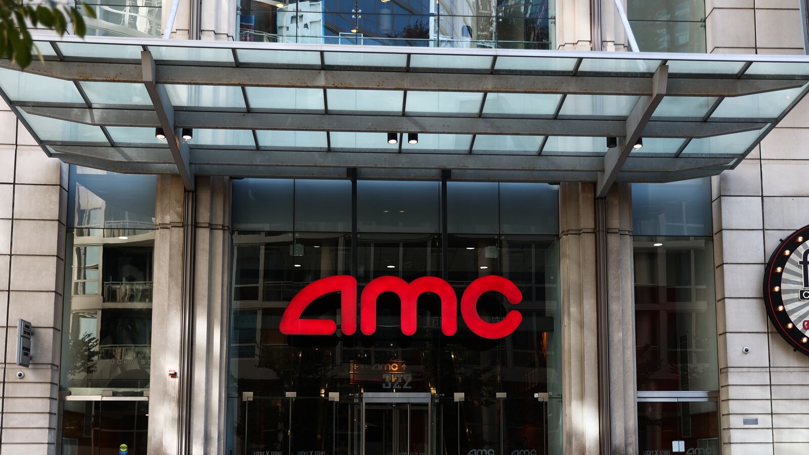 AMC logo is seen on a building. AMC Theaters is abandoning a tiered-pricing plan to charge more for better seats in its theaters.