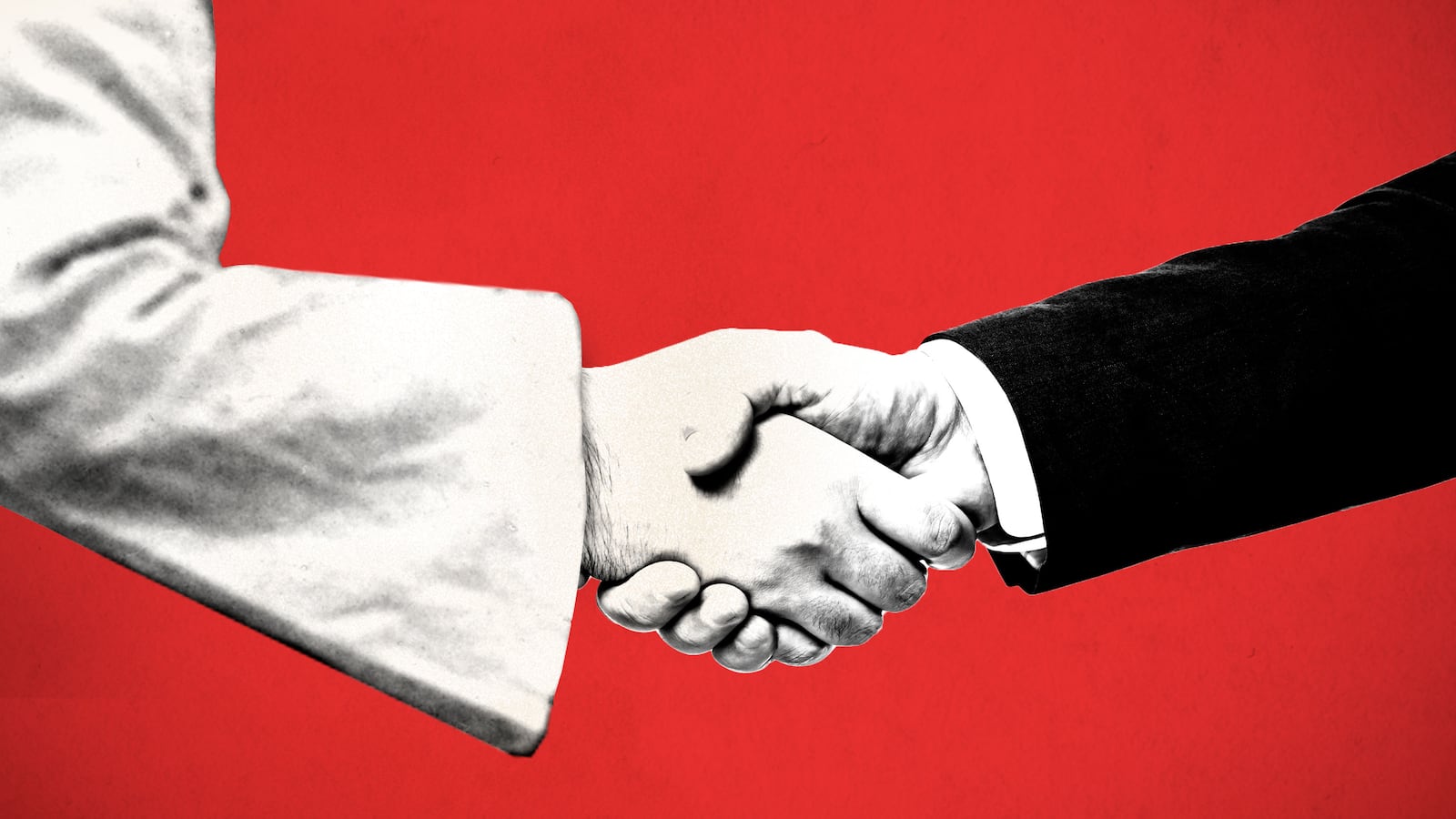 A closeup of a handshake between a business man and a man wearing a white robe