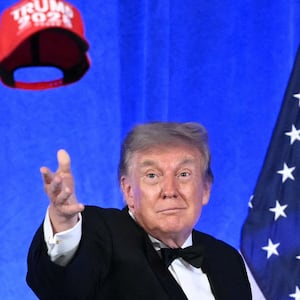 Donald Trump throws his "Trump 2028" hat into an unappreciative audience at this year's 2026 White House Correspondents' Association Dinner.