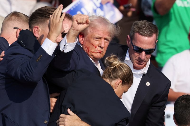 Donald Trump is assisted by the Secret Service after gunfire rang out during a campaign rally at the Butler Farm Show in Butler, Pennsylvania, U.S., July 13, 2024.