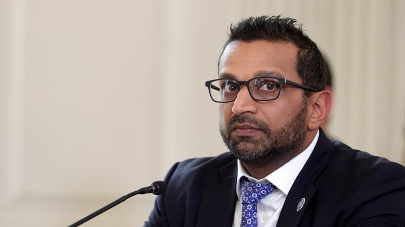 Director of the Federal Bureau of Investigation (FBI) Kash Patel listens as U.S. President Donald Trump delivers an announcement