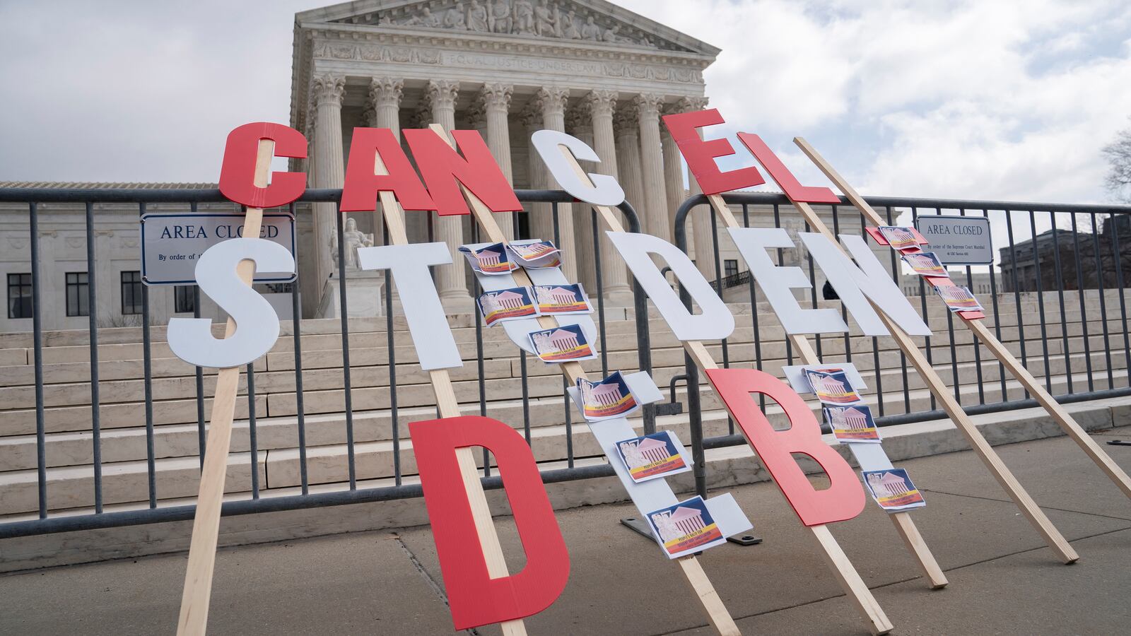 Student Loan debt protest signs in front of the supreme court