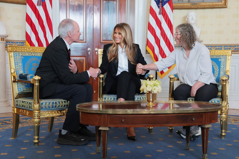 WASHINGTON, DC - FEBRUARY 04: First lady Melania Trump, Keith Siegel (L) and Aviva Siegel (R) holds hands during a meeting in the Blue Room of the White House on February 04, 2026 in Washington, DC. Keith Siegel, a U.S. citizen, was freed from Hamas captivity on February 1, 2025 after spending 484 days in captivity. Aviva Siegel was also held captive and released in November 2023. (Photo by Anna Moneymaker/Getty Images)