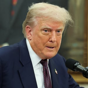 U.S. President Donald Trump speaks, as he and Apple CEO Tim Cook (not pictured) present Apple's announcement of a $100 billion investment in U.S. manufacturing, in the Oval Office at the White House in Washington, D.C., U.S., August 6, 2025. REUTERS/Jonathan Ernst