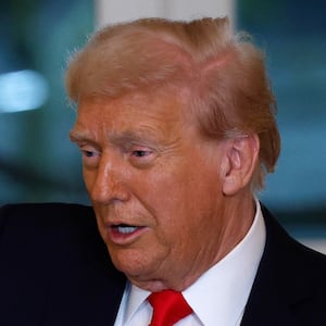 Trump holds a model of an arch