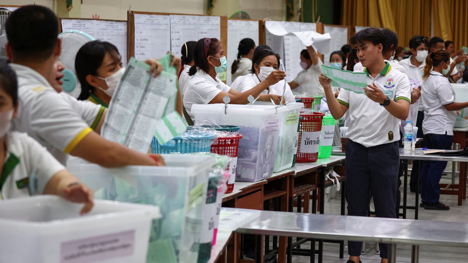 Workers count votes as the polling stations close on the day of the general elections in Bangkok, Thailand.