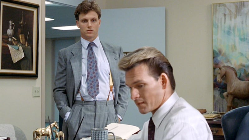 The movie "Ghost", directed by Jerry Zucker and written by Bruce Joel Rubin. Seen here, from left, Tony Goldwyn as Carl Bruner observes Patrick Swayze as Sam Wheat working at Market Security Bank & Trust.